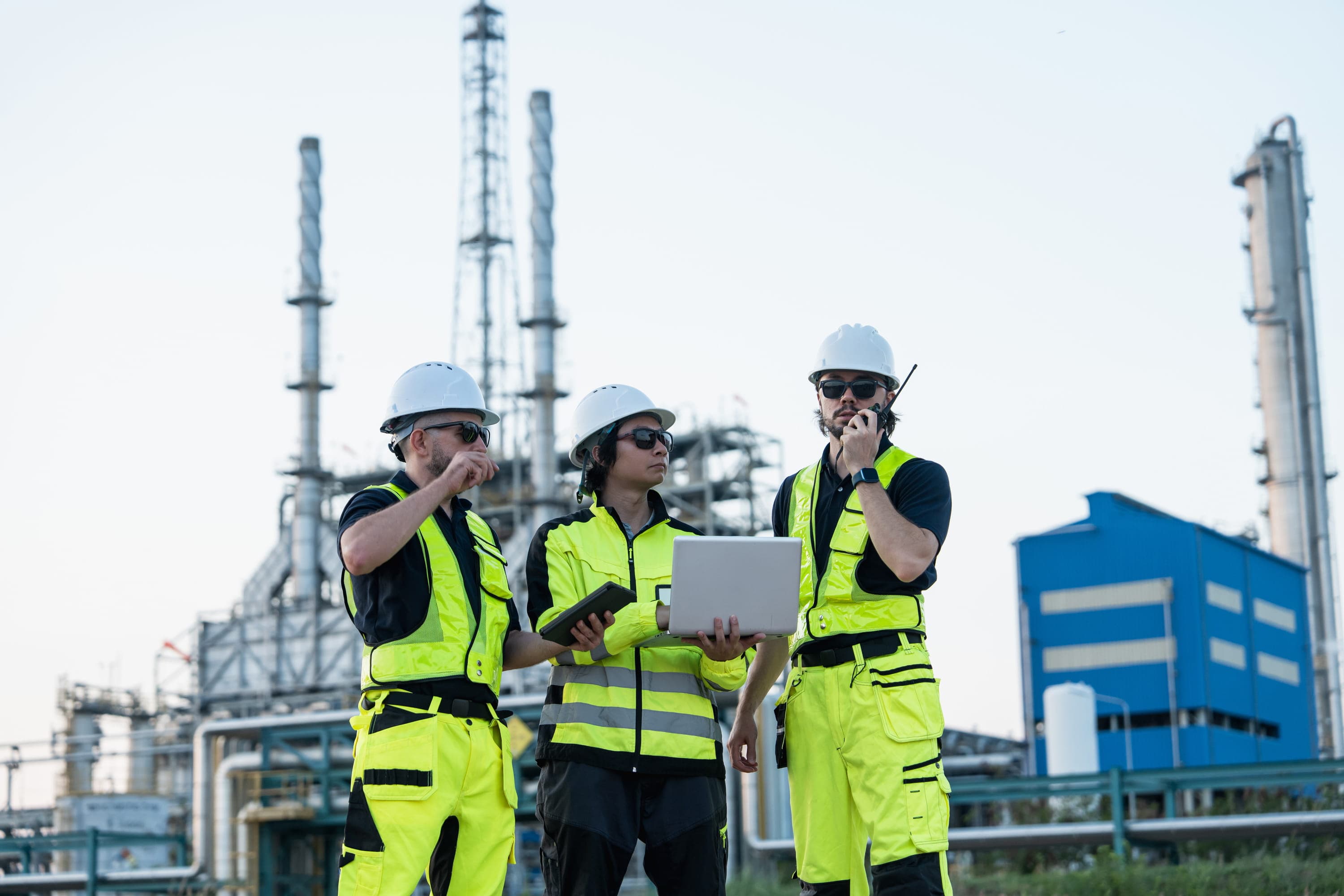 Worker in hard hat and safety gear at an industrial facility